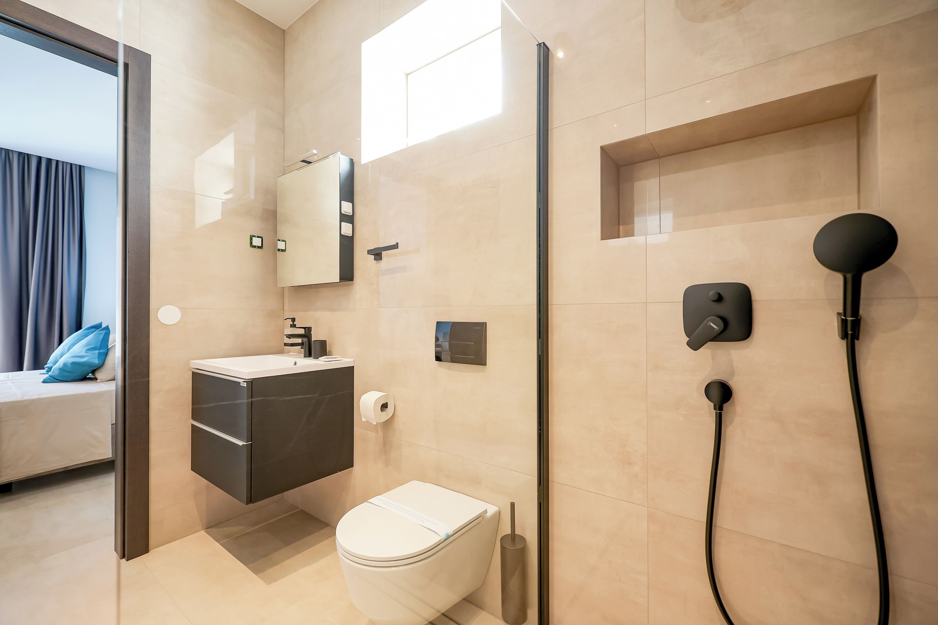 A modern bathroom with a toilet, sink, and shower.