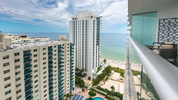 A high-rise hotel with a pool and beach view. - 1BR Beach Condo | Sea View | Hollywood Broadwalk (Hollywood)