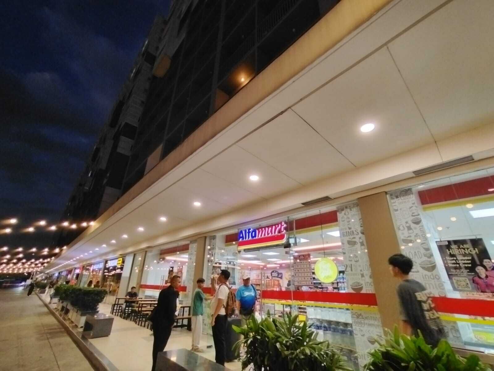 A brightly lit storefront with a prominent sign for 'Aifa Mart'.