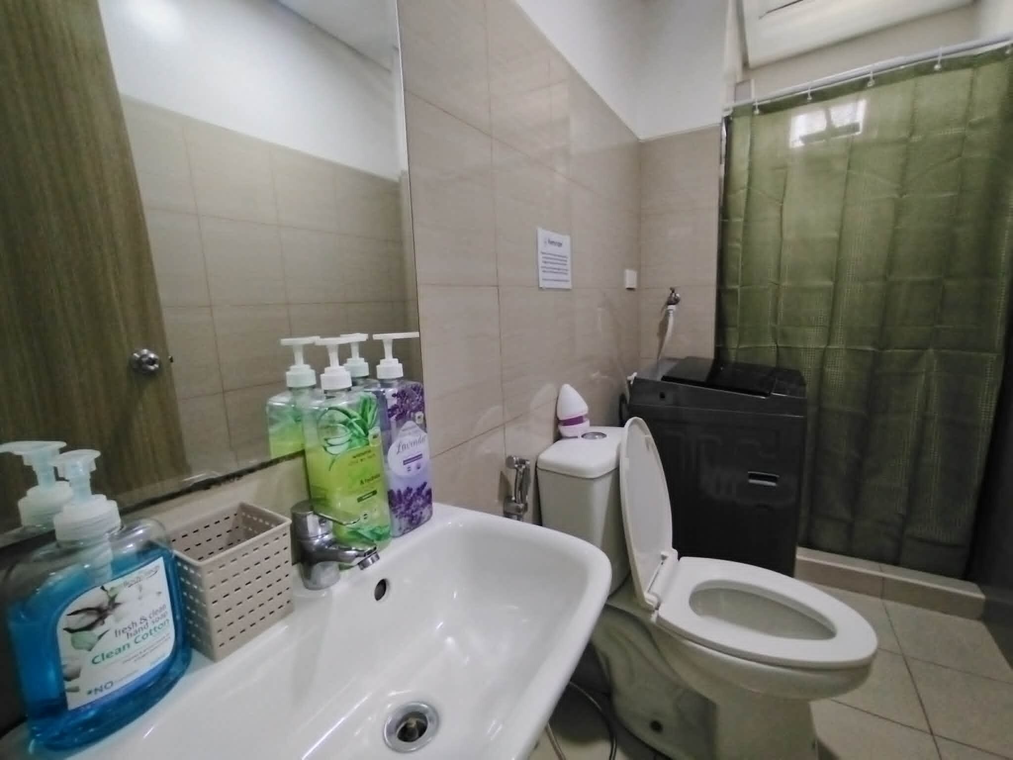 A bathroom with a sink, toilet, and shower.