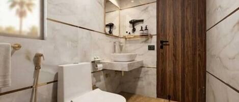 A bathroom with a toilet, sink, and wooden door.