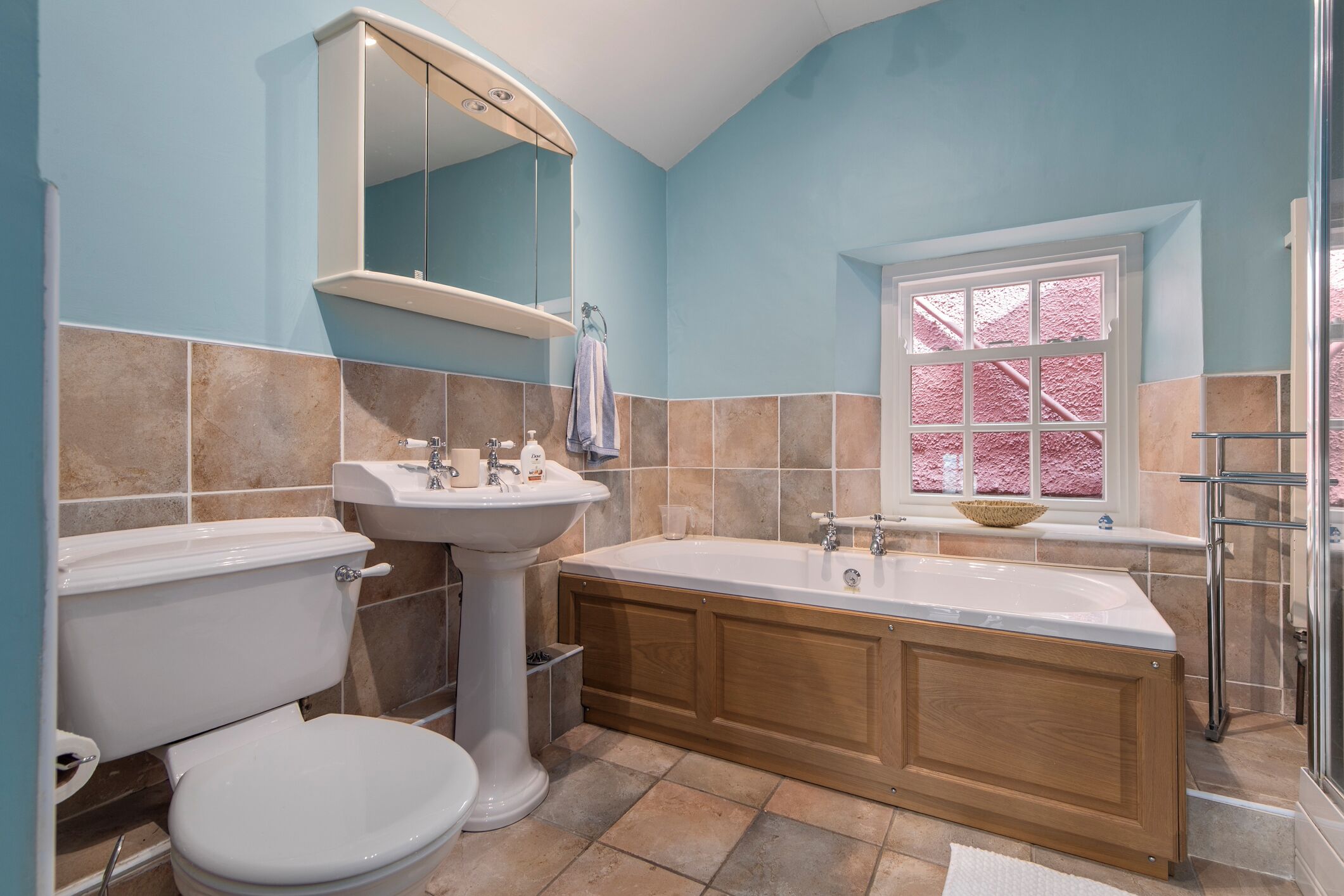 A bathroom with a toilet, sink, and bathtub.