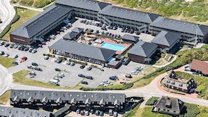 An aerial view of a hotel with multiple buildings, a swimming pool, and a parking lot. - 4 Person Holiday Home on a Holiday Park in Fano (Fano)