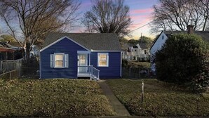 A small, single-story house with a front porch and a pathway leading to the entrance. - Stylish 3BR Getaway • Near Downtown & Restaurants (Richmond)