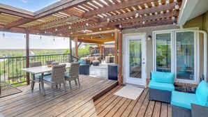 A wooden deck with outdoor furniture, a pergola with string lights, and a glass door leading to an interior space. - Outdoor Oasis w/ Lake Views: Ransom Canyon Retreat (Ransom Canyon)