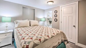 A bedroom with a bed, nightstands, a door, and wall decorations. - Modern Salt Lake City Apt.- 20mi to Snowbird! (Salt Lake City)