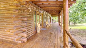 A log cabin with a wooden deck and a covered porch. - 3,000 Sq Ft + Game Room: Ozarks Serenity Cabin! (Harrison)