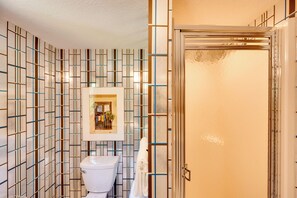 A bathroom with a tiled wall, a toilet, and a shower area. - White Mountain Retreat! 3 Mi to Cannon Mountain (Franconia)