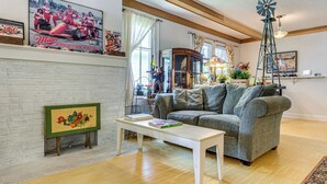 A living room with a fireplace, a windmill, and a sofa.