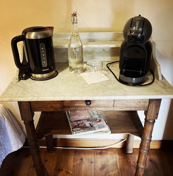 A kitchen counter with a coffee maker, a bottle, and a glass. - Nature break in the monk's room, wellness area on site! (Saint-Arcons-d'Allier)