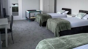 A hotel room with two beds, a desk, and a wardrobe. - Cortoon Inn, Family Room 1 (1DBL +2SGL) (Tuam)