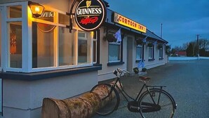 A building with a Guinness sign and a Cartoon Inn sign. - Cortoon Inn, Twin Room 3 (2 SGL) (Tuam)