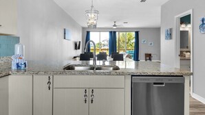 A modern kitchen with granite countertops, stainless steel appliances, and a dishwasher.