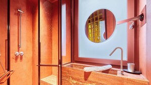 A modern bathroom with a glass shower enclosure, a marble sink, and a round mirror. - Sublime Apartment Beaubourg/le Marais (Paris)