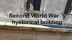 A historical building with multiple windows and a weathered facade, likely from the Second World War era. - Imperium Suite Trevi (Rome)