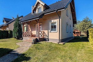 A two-story building with a covered porch, a sign reading 'Villa Von Valdi,' and a well-maintained lawn.