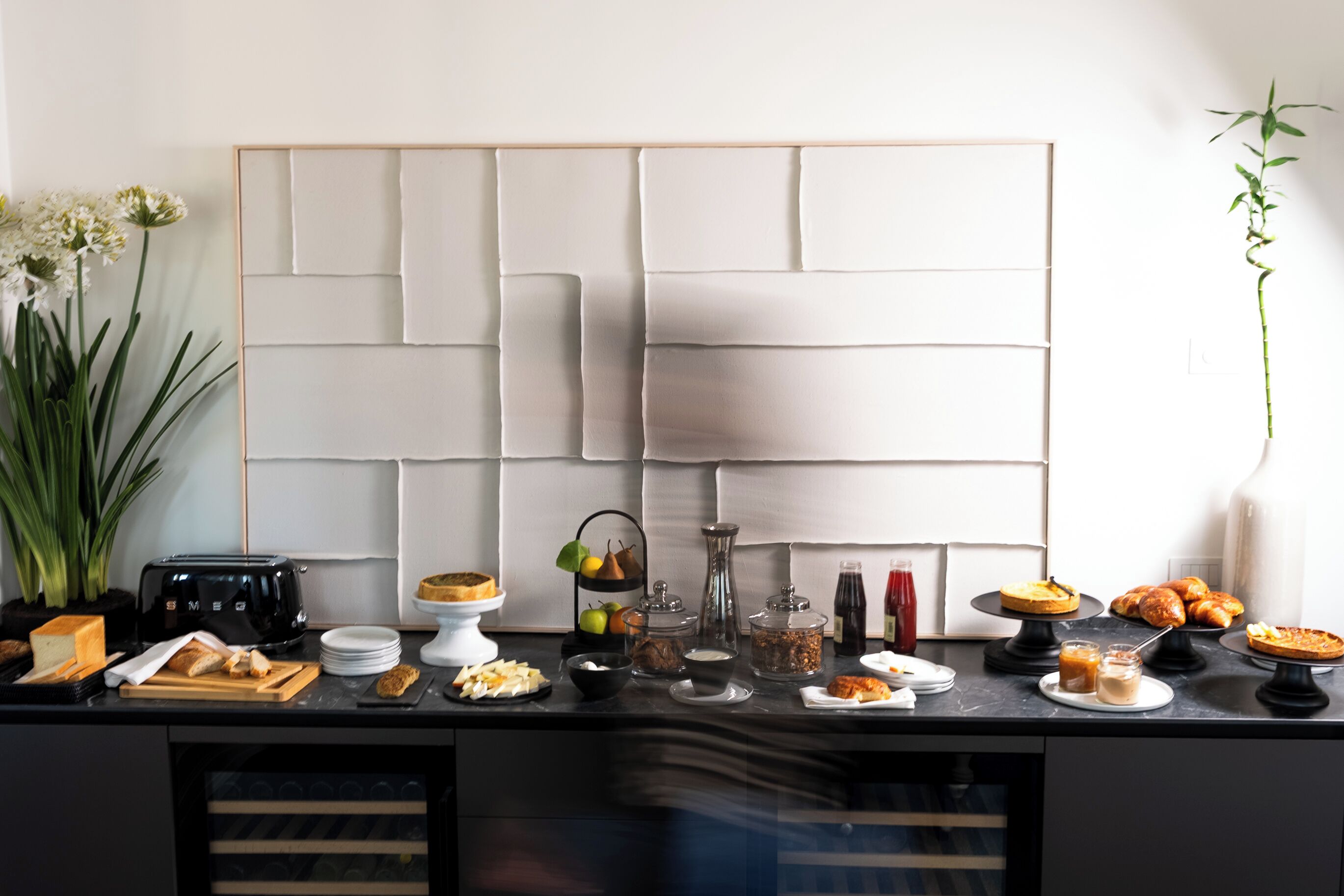 A kitchen counter with various food items and kitchen appliances.