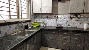 A kitchen with a sink, a window, and cabinets.