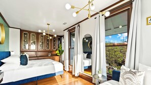 A bedroom with two beds, a large window, and a view of the outdoors. - Top 2 Floors Historic Mansion,Game Room,City Views (San Diego)