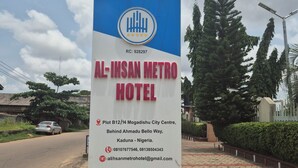 A sign for Al-Ihsan Metro Hotel, indicating its location at Plot B12/14 Mogadishu City Centre, Behind Ahmadu Bello Way, Kaduna - Nigeria. - Al-Ihsan Metro Hotel (Kaduna)
