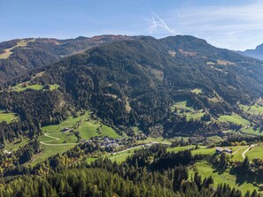 A mountainous landscape with a village nestled in the valley.