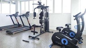 A gym with treadmills, a weight machine, and exercise bikes.