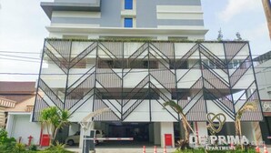 A modern multi-story building with a distinctive zigzag balcony design.