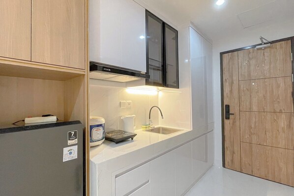 A modern kitchen with a built-in refrigerator, a microwave, and a sink.