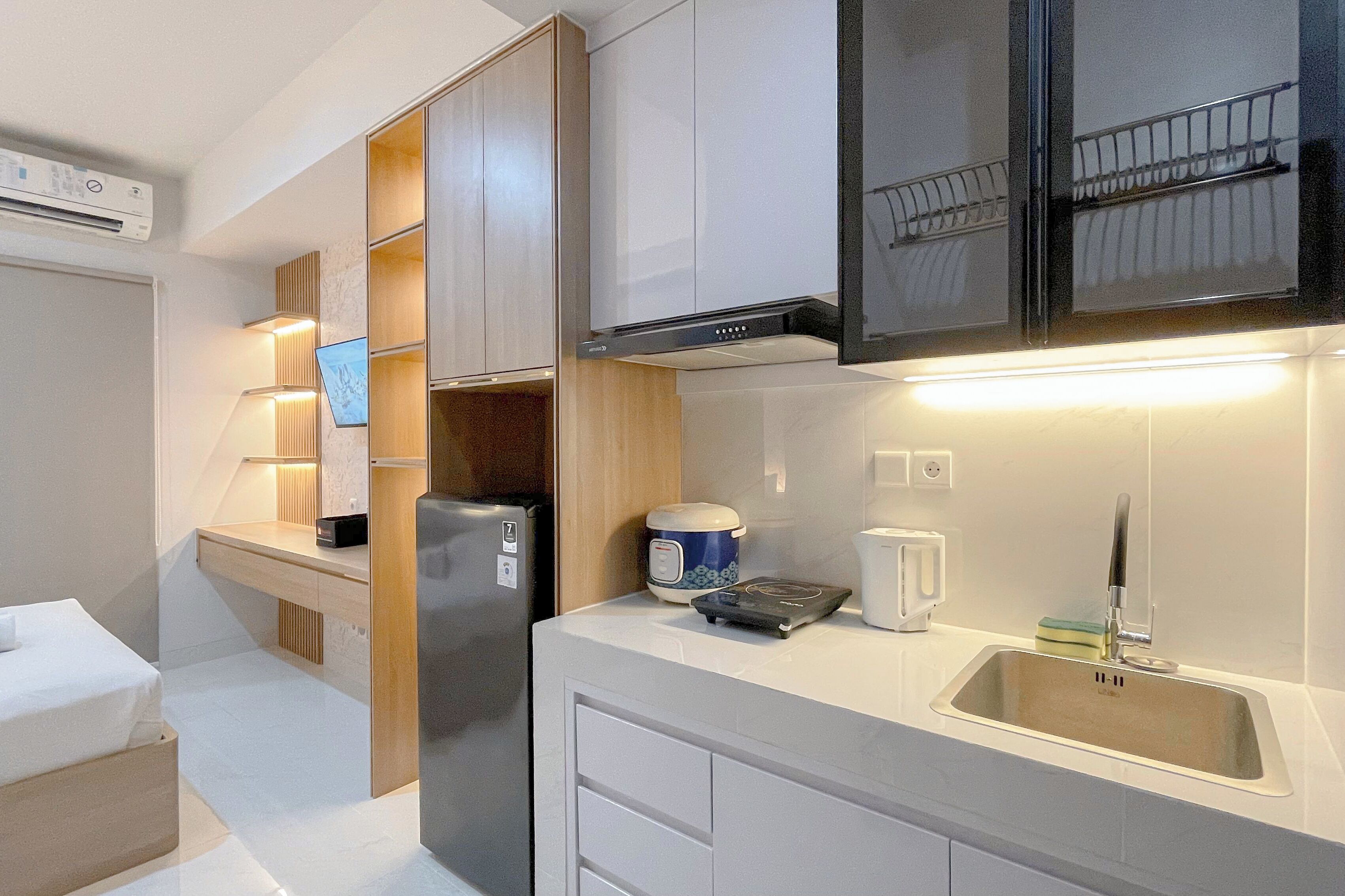 Een moderne keuken met inbouwapparatuur, een aanrecht met waterkoker, broodrooster en spoelbak.