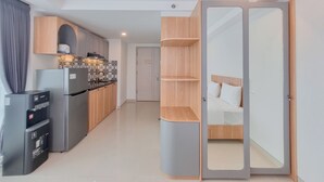 A modern kitchen with a built-in refrigerator, wooden cabinets, and a patterned backsplash.