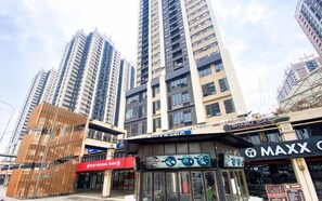 A commercial area with high-rise buildings, a bank, and various shops including a jewelry store. - Warm And Cozy 2Br Meikarta Apartment (Cikarang)