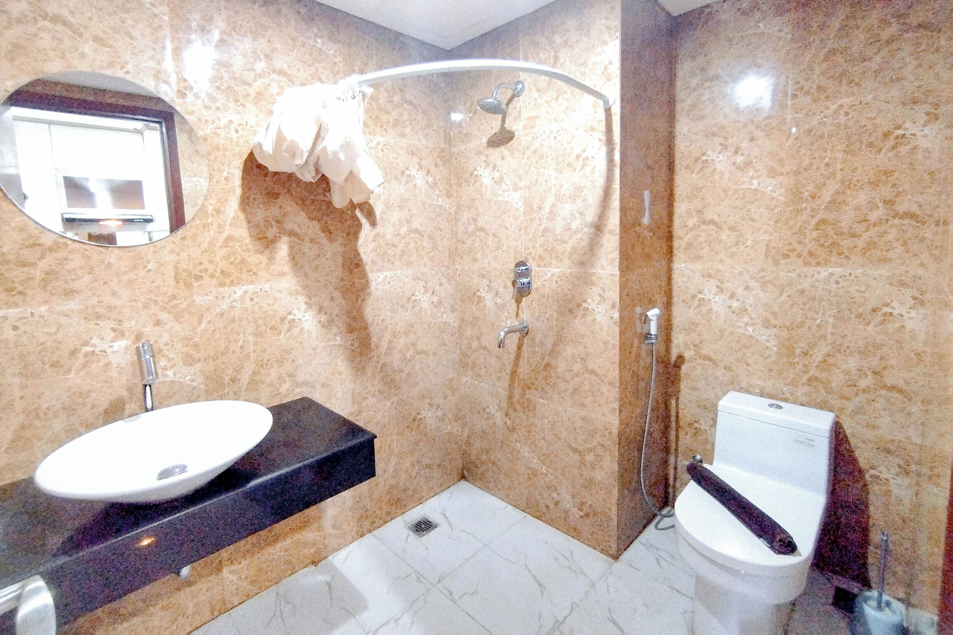 A bathroom with a sink, toilet, and shower.