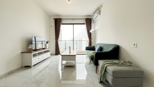 A modern living room with a flat-screen TV, a coffee table, a sofa, and a balcony with curtains. - Quiet And Homey 2Br With Extra Room Apartment Sky House Bsd (Pagedangan)