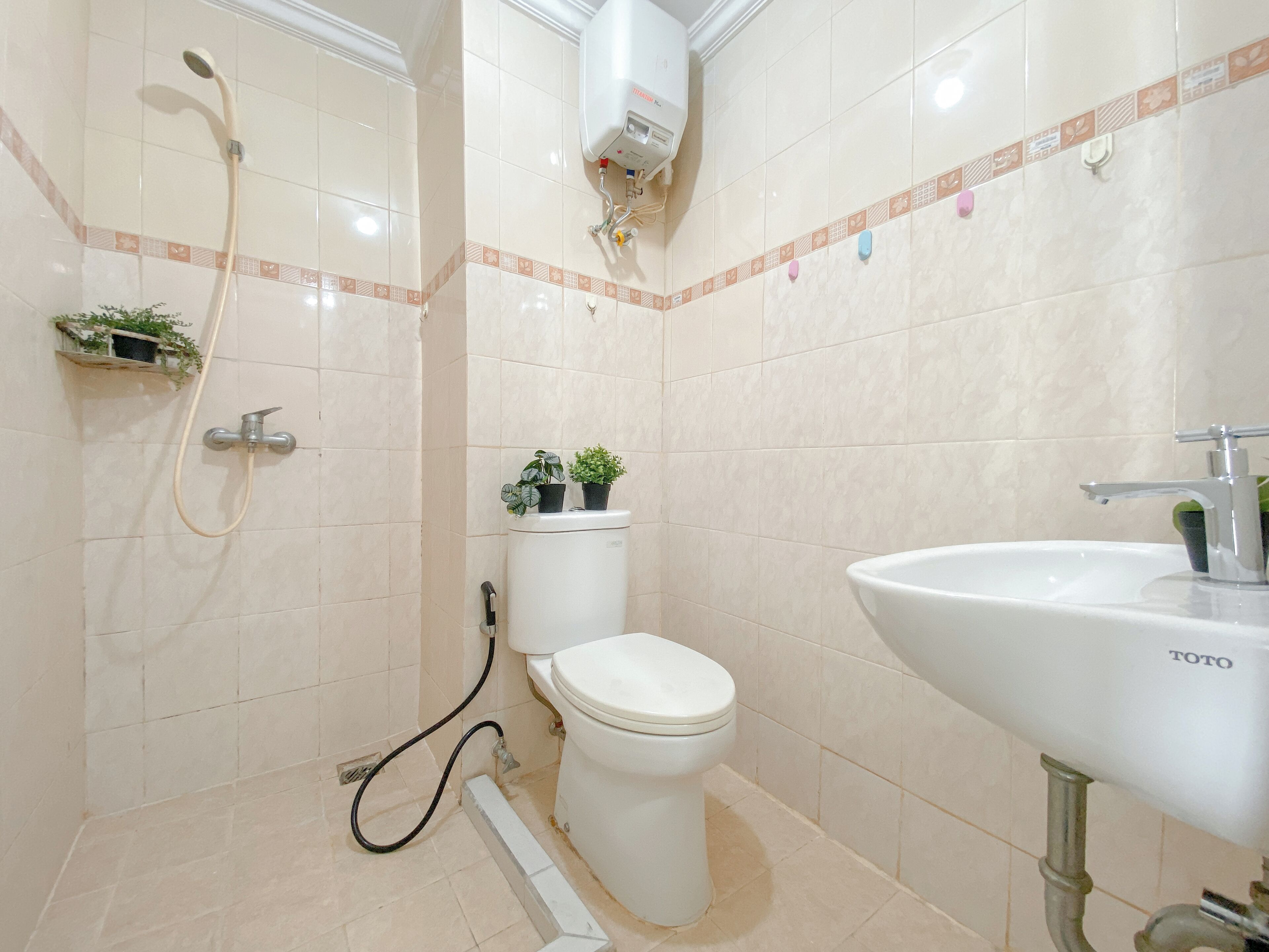A bathroom with a toilet, a sink, and a shower.