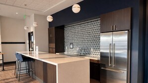 A modern kitchen with a central island, stainless steel appliances, and pendant lighting. - Deer District Studio Apt - One Block from Fiserv and Baird (Milwaukee)