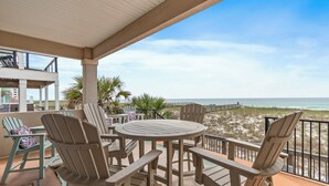 A covered outdoor seating area with a view of the beach. - Navarre Beachfront Townhome Southern Cross Sleeps 13 + Pet Friendly (Navarre)