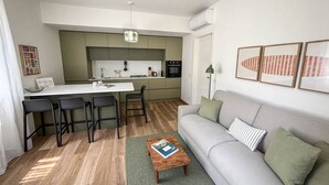 A modern apartment with a kitchen, dining area, and living room.