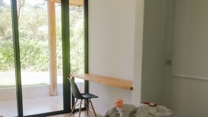A bedroom with a bed, a chair, and a desk. - Modern Hideaway with Pool –  Near Sámara Location! (Sámara)