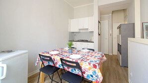 A compact kitchen with white cabinets, a dining table set for two, and a small refrigerator. - GuestHost - Cozy 50 sqm studio apartment, perfect for a stay of two people, located on the first floor of a building with elevator (NOT suitable for disabled people).The property is located in the San Zeno district, a few steps from the Museum and the ma (Verona)