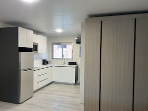 Fridge, microwave, stovetop, coffee/tea maker