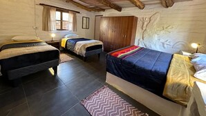 Une chambre avec deux lits, un plafond en bois et une décoration rustique.