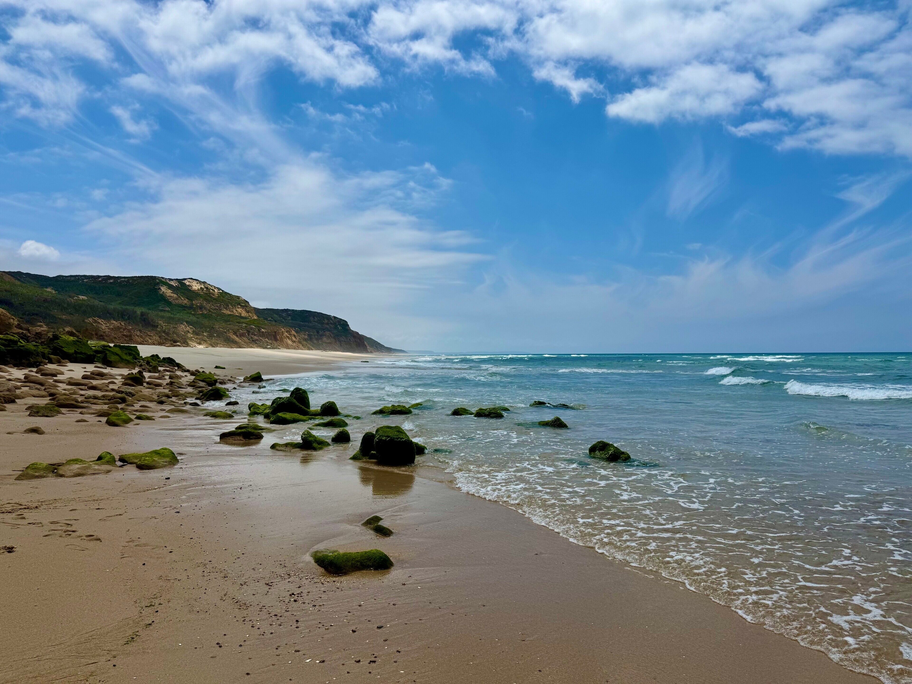 A beach with rocks and waves.