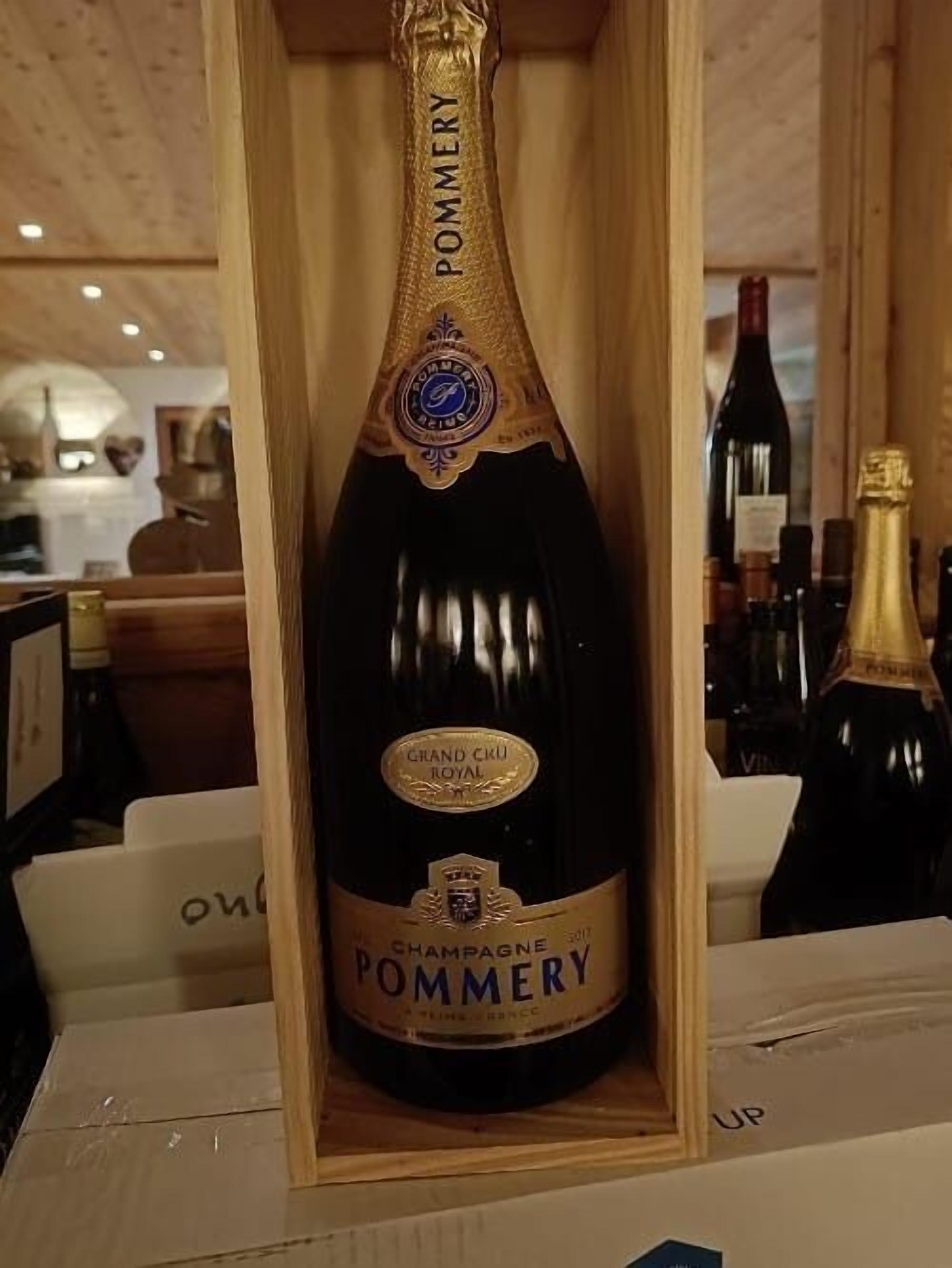 A bottle of Grand Cru Royal Champagne Pommery in a wooden box.