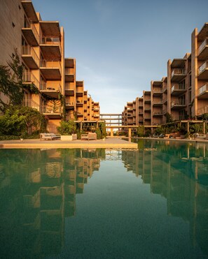 A modern apartment complex with a central courtyard and a swimming pool.
