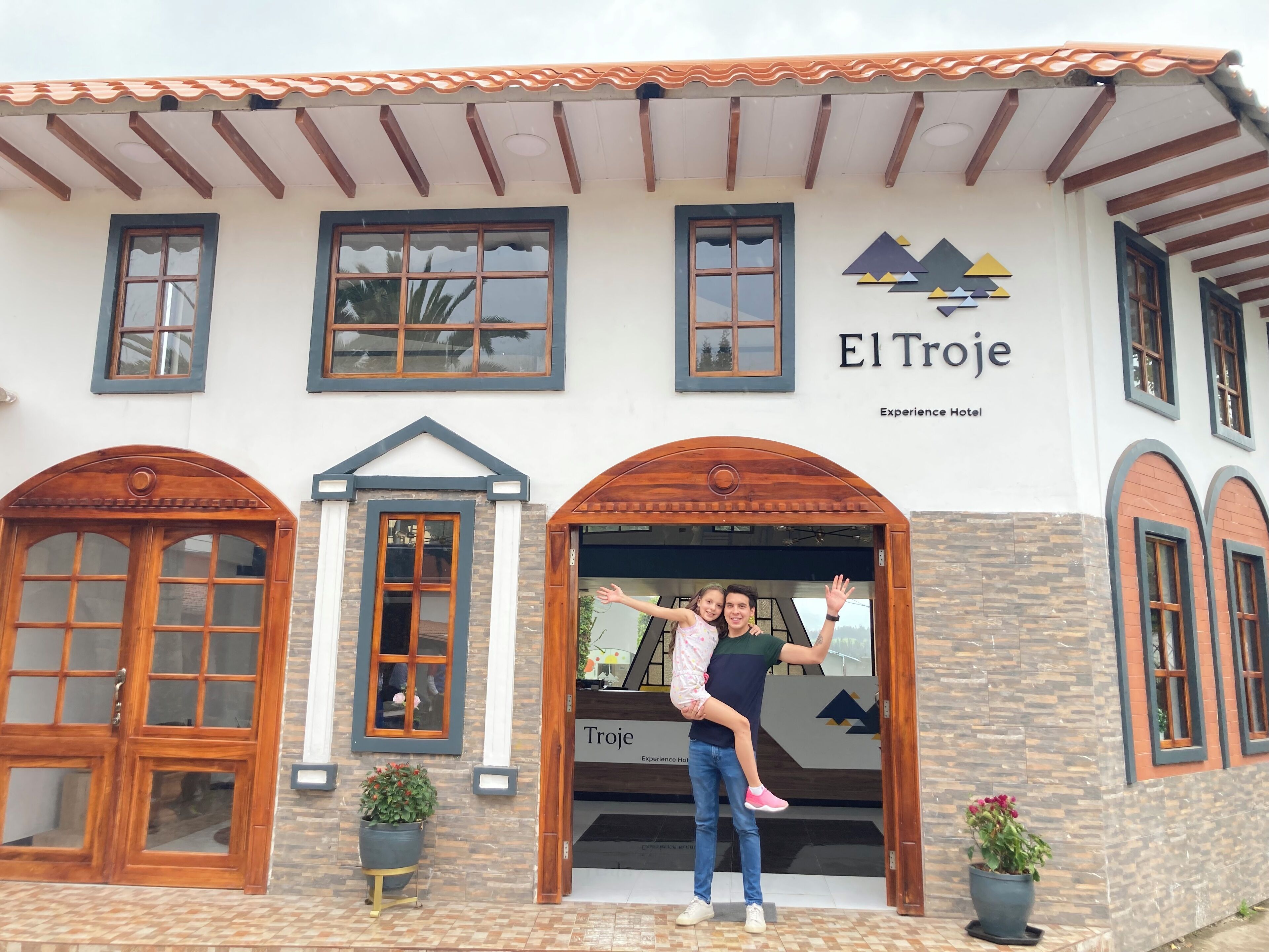 Entrada de um hotel com uma placa indicando 'El Troje Experience Hotel'.