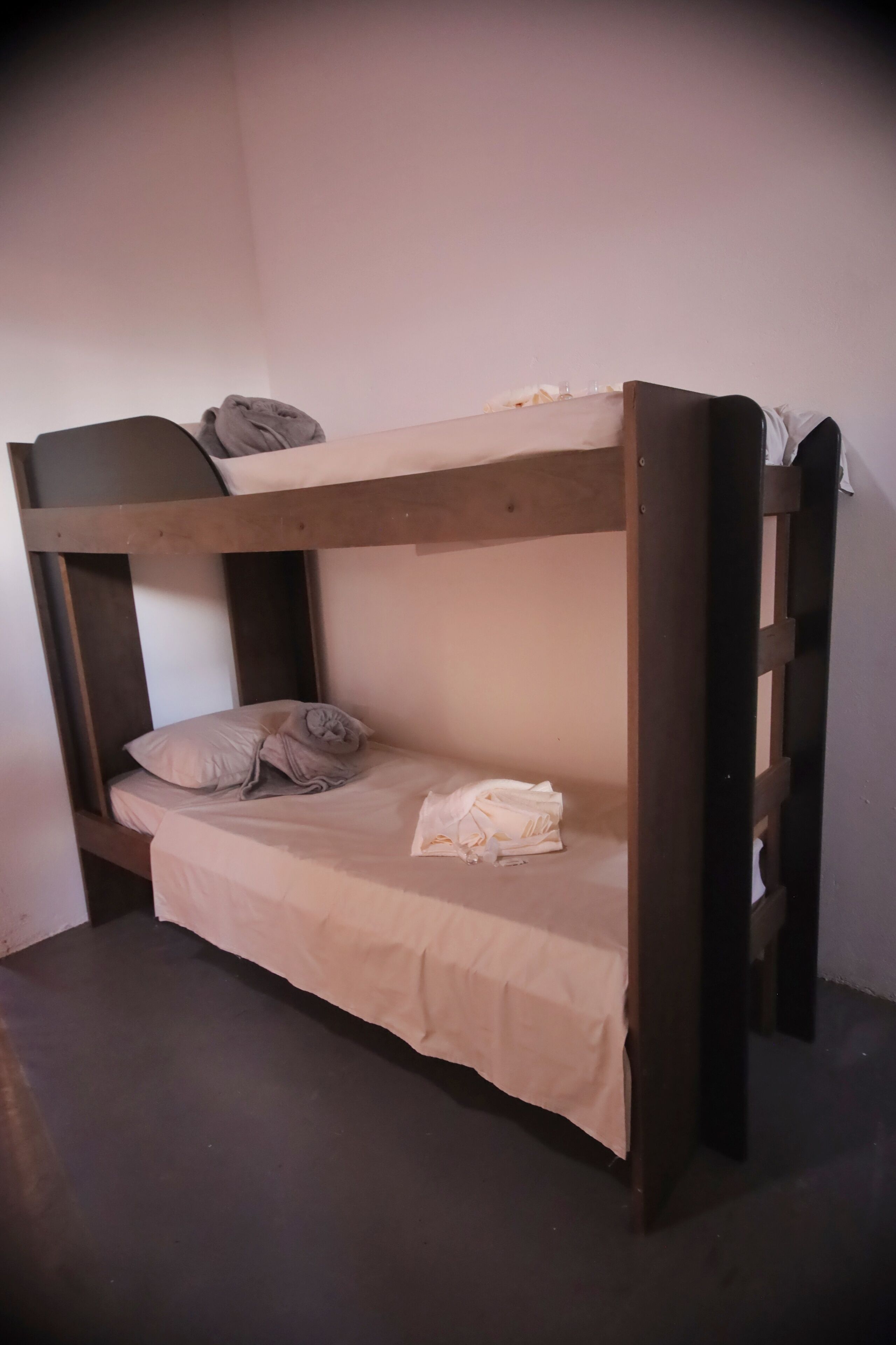 A bunk bed with a mattress and pillows.