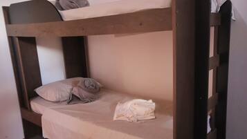 A bunk bed with a mattress and pillows.