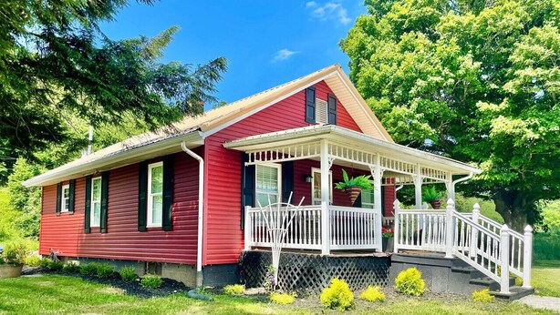 A red house with a white porch and a small staircase leading up to it. - Two Bedroom House Close to Local Favorites (West Lafayette)