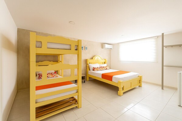 A room with a bunk bed, a single bed, a window with blinds, and a radiator. - Taybo House By St Hoteles (San Andrés)