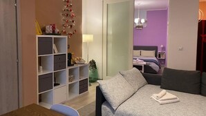 A bedroom with a bed, a desk, and a shelving unit. - Chagall Apartment - no ZTL (Asti)